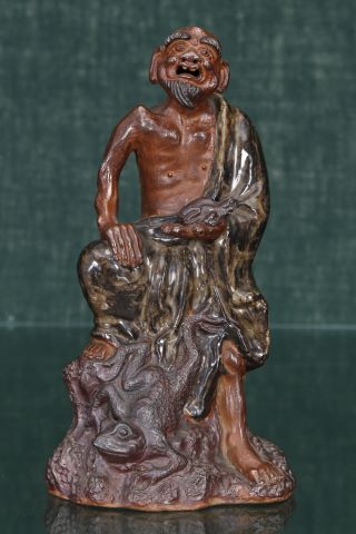 Chine Vieil homme tenant une grenouille